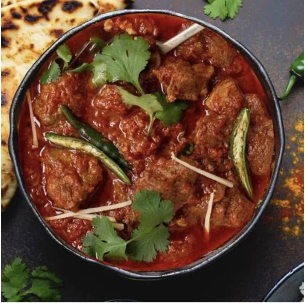 Red meat curry with ginger and green chilli served with naan